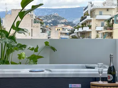 a table with a bottle of wine and a glass at AirRent Apartments 4 Jacuzzi Suite in Athens