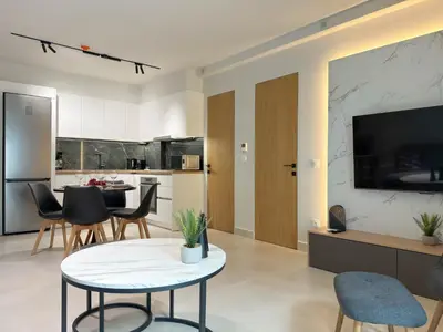 a kitchen and living room with a table and chairs at AirRent Apartments 4 Jacuzzi Suite in Athens