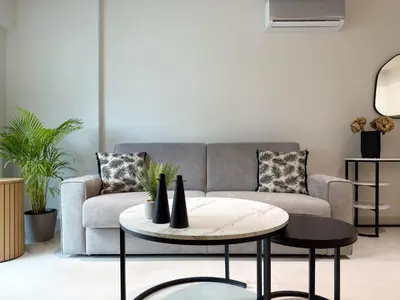 a living room with a couch and a table at AirRent Apartments 4 Jacuzzi Suite in Athens