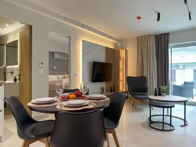 a dining room and living room with a table and chairs at AirRent Apartments 4 Jacuzzi Suite in Athens