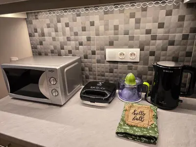 a kitchen counter with a microwave and a bag of food at Dream Home Apartment by Metro in Athens