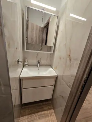 a bathroom with a sink and a mirror at Dream Home Apartment by Metro in Athens