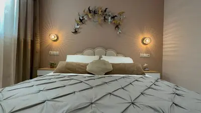 a bedroom with a large bed and two lights at Mocha Luxury Residence in Spáta