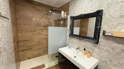 a bathroom with a sink and a mirror at Mocha Luxury Residence in Spáta