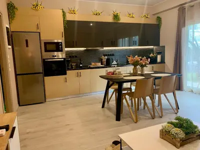 a kitchen with a table and chairs in a room at Mocha Luxury Residence in Spáta