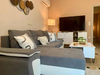a living room with a couch and a flat screen tv at Mocha Luxury Residence in Spáta