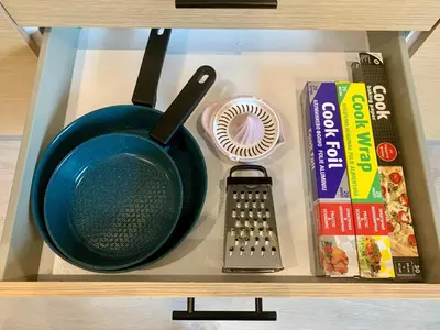 a cabinet with a frying pan and other food items at Mocha Luxury Residence in Spáta