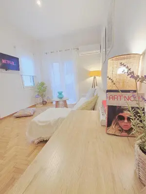 a living room with a wooden table in a room at Athens F&K Premium City Home in Athens