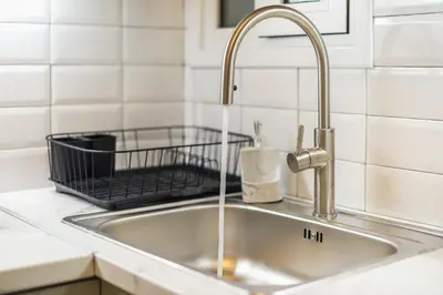 a sink in a kitchen with a faucet at Athens F&K Premium City Home in Athens