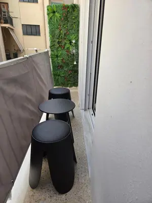two black stools sitting on the side of a building at Athens F&K Premium City Home in Athens