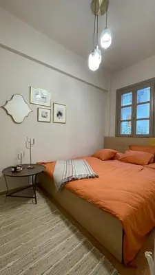 a bedroom with a large bed and a table at Chillout in Athens in Athens