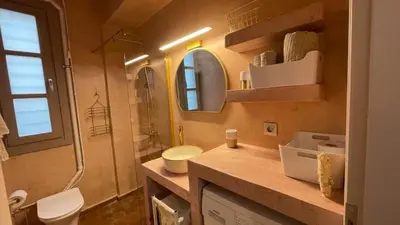 a bathroom with a sink and a toilet and a mirror at Chillout in Athens in Athens