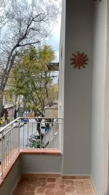 a balcony with a clock on the side of a building at Chillout in Athens in Athens