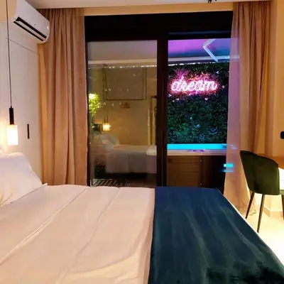 a hotel room with a bed and a sign in the window at The Dream Suite in Piraeus