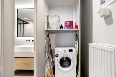 a laundry room with a washer and dryer in a bathroom at Avia Deluxe Studio - Athens Modern Escape in Athens