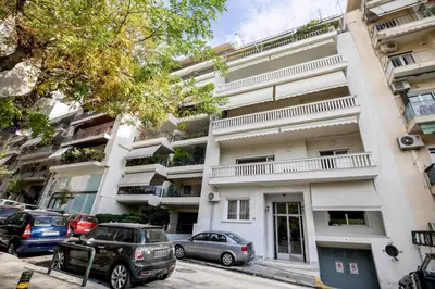 a building with cars parked in front of it at Avia Deluxe Studio - Athens Modern Escape in Athens