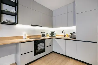 a white kitchen with white cabinets and a sink at Avia Deluxe Studio - Athens Modern Escape in Athens