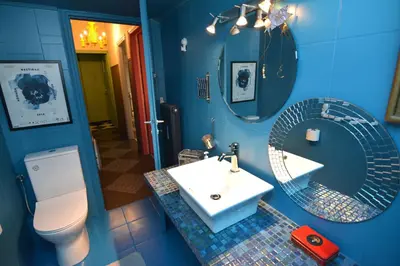 a blue bathroom with a sink and a mirror at Bibelot Acropolis in Athens