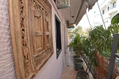 a large wooden door on a building with potted plants at Bibelot Acropolis in Athens