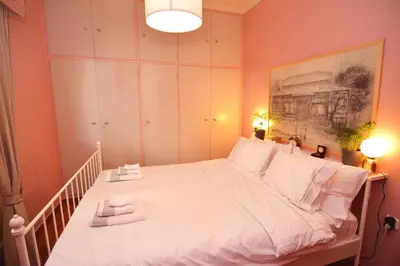 a bedroom with a large bed with white pillows at Bibelot Acropolis in Athens