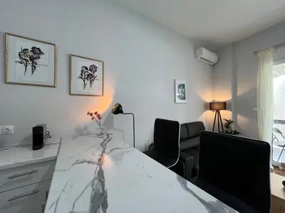 a living room with a white table and chairs at Charming Apartment in the center of Athens in Athens