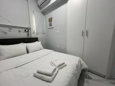 a bedroom with a white bed with towels on it at Charming Apartment in the center of Athens in Athens