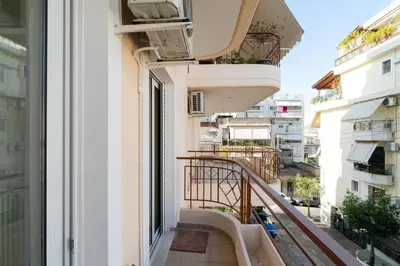 a balcony of a building with an open window at \u51ef\u5b81\u6c11\u5bbf in Piraeus