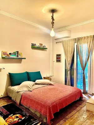 a bedroom with a large bed with a red blanket at Couple Nest in Athens