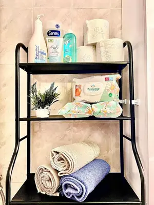 a shelf with towels and other products on it at Couple Nest in Athens