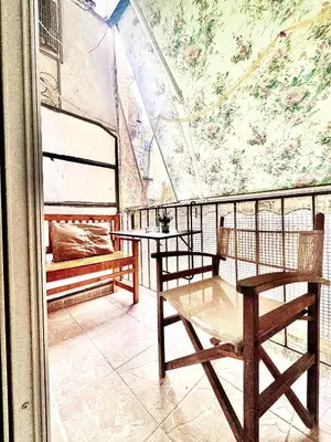 a balcony with two tables and benches and a mural at Couple Nest in Athens