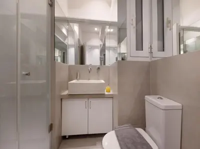 a bathroom with a toilet and a sink at Acropolis Museum Retreat by GHH in Athens