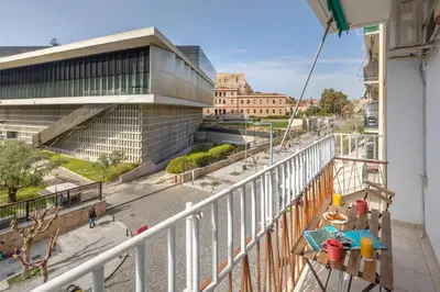 a balcony with a view of a building at Acropolis Museum Retreat by GHH in Athens