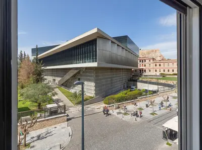 a view of a building from a window at Acropolis Museum Retreat by GHH in Athens