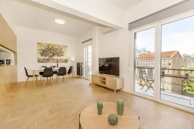 a living room with a table and a large window at Acropolis Museum Retreat by GHH in Athens