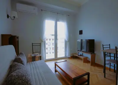a living room with a couch and a table at Alexandras Park View in Athens