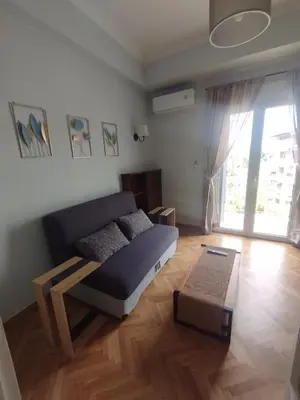 a living room with a couch and a table at Alexandras Park View in Athens