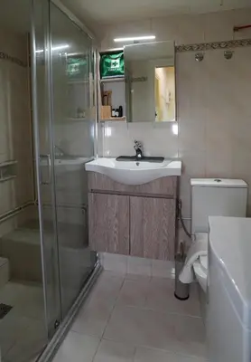 a bathroom with a sink and a shower and a toilet at Alexandras Park View in Athens
