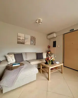 a living room with a couch and a table at Pearl Villa and Apartment near Beach and Athens Airport in Porto Rafti