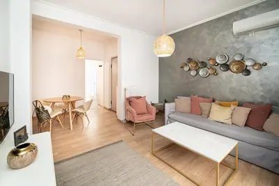 a living room with a couch and a table at Athens Due Montagne Apartment in Athens