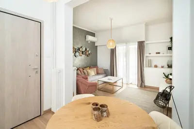 a living room with a table and a couch at Athens Due Montagne Apartment in Athens