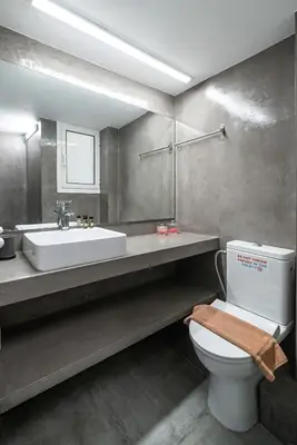 a bathroom with a white toilet and a sink at Athens Due Montagne Apartment in Athens