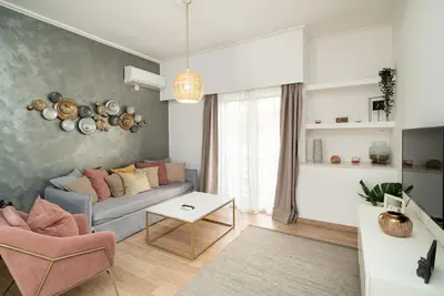 a living room with a couch and a table at Athens Due Montagne Apartment in Athens