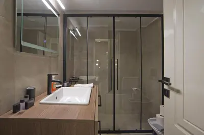 a bathroom with a sink and a shower at Denimou Home Luxurious 2BR Fully Equipped, Balcony in Piraeus