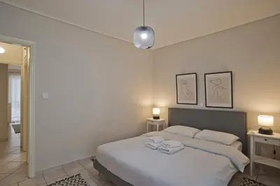 a bedroom with a bed with two towels on it at Denimou Home Luxurious 2BR Fully Equipped, Balcony in Piraeus