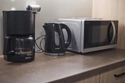 a microwave and a coffee maker on a kitchen counter at Denimou Home Luxurious 2BR Fully Equipped, Balcony in Piraeus