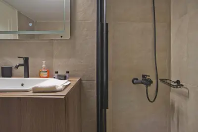 a bathroom with a shower and a sink at Denimou Home Luxurious 2BR Fully Equipped, Balcony in Piraeus