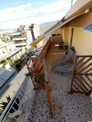 a balcony with chairs and a view of a city at Downtown Cozy penthouse For balcony lovers in Athens