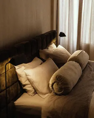 a bed with a bunch of pillows on it at Luxurious loft in Monastiraki in Athens
