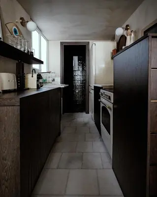 a kitchen with black cabinets and a tile floor at Luxurious loft in Monastiraki in Athens