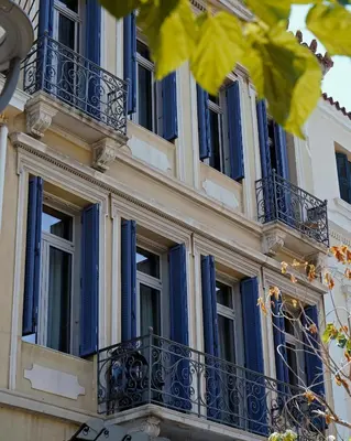 a building with blue windows and balconies at Luxurious loft in Monastiraki in Athens